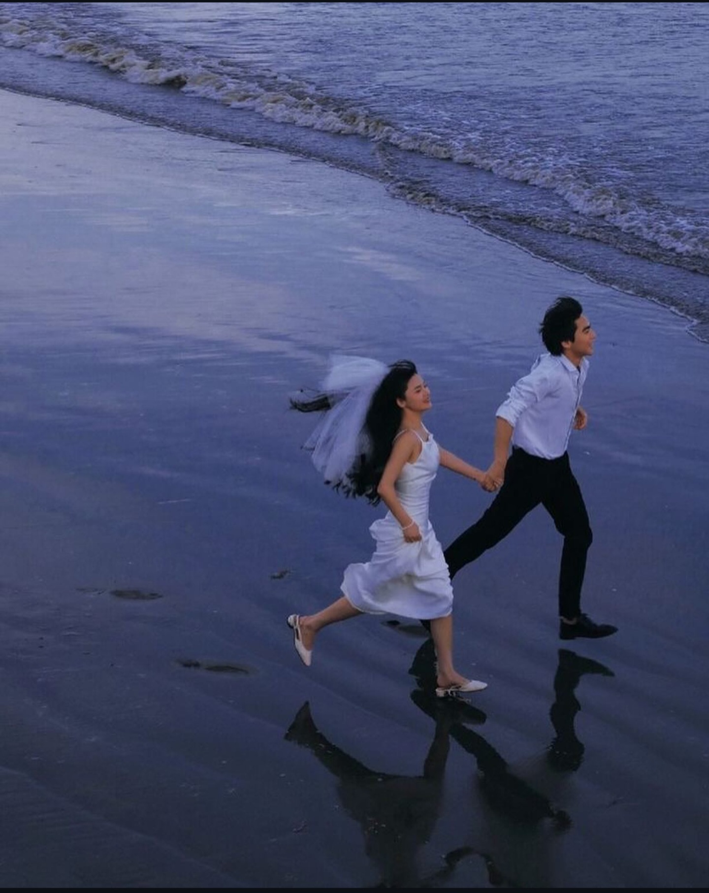 Couple running on beach