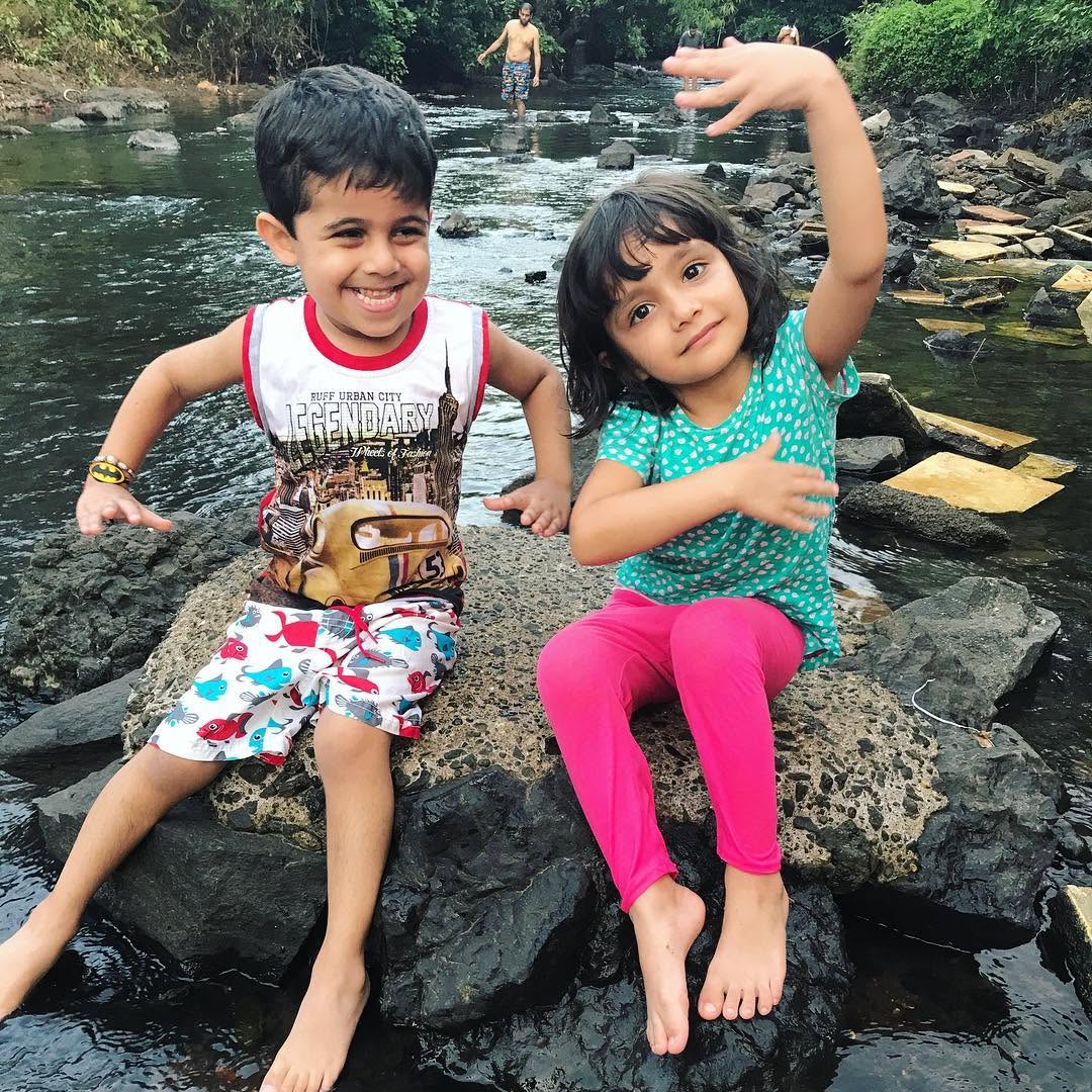 Little explorers on the river rocks