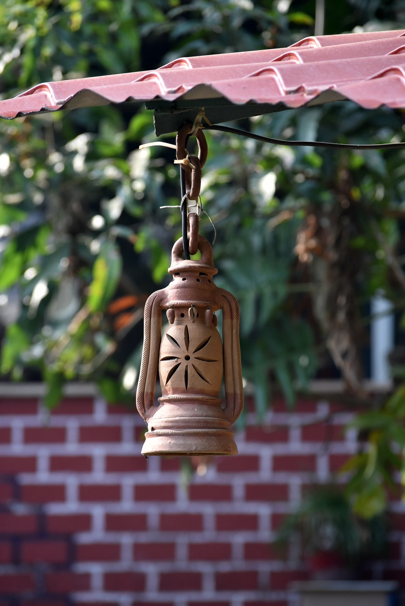 A terracotta lantern under the tiles