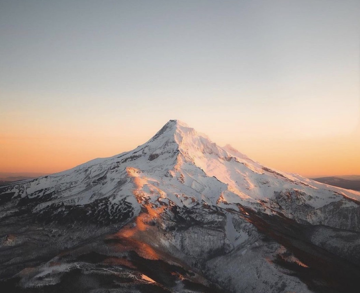Mt. Hood at first light, snow-capped alpine peak in golden hour above Government Camp