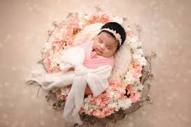 Newborn in floral wreath by Mitcy Photography