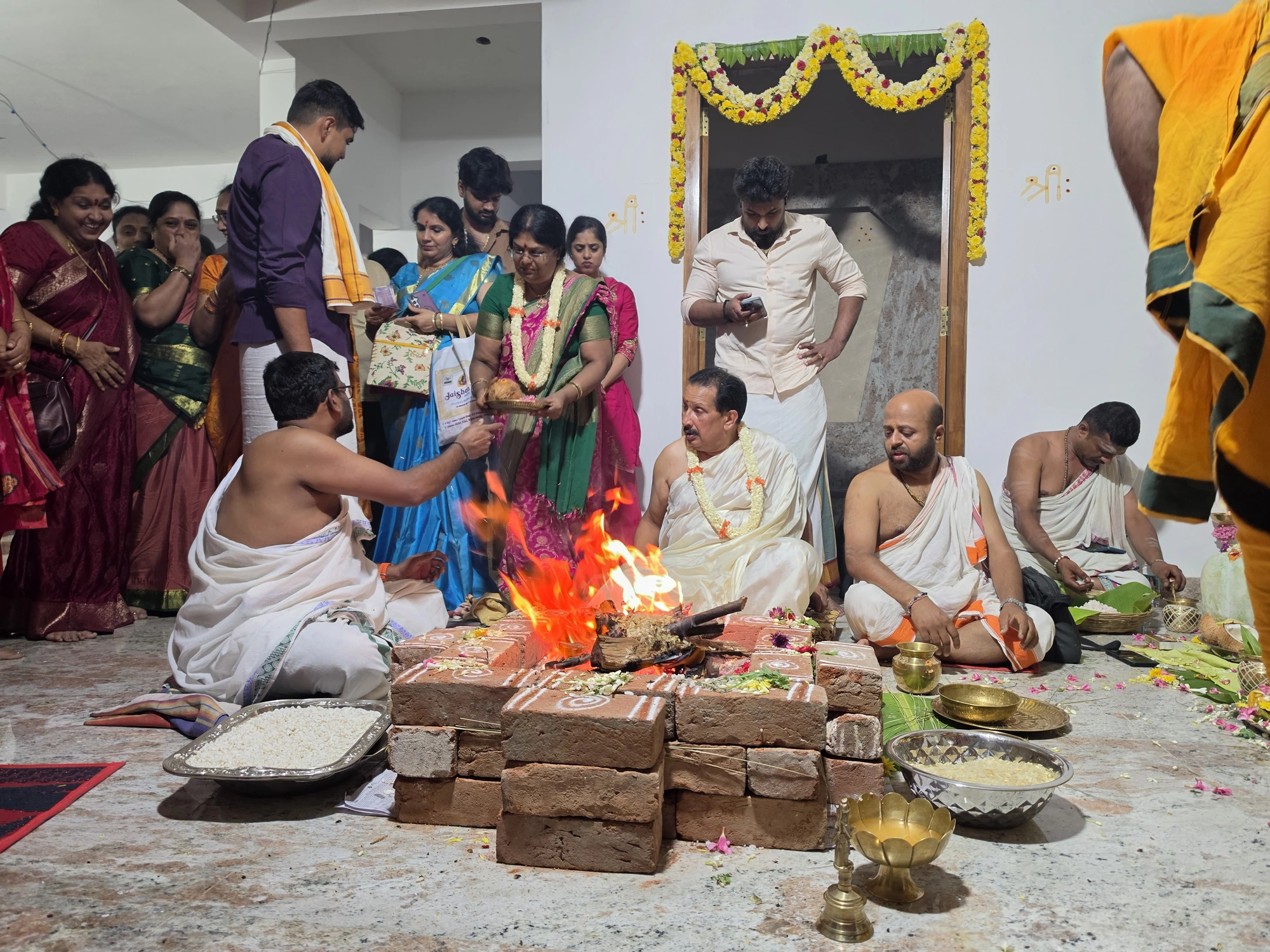 Group parayana beside the decorated Lakshmi and Venkateshwara mantapa