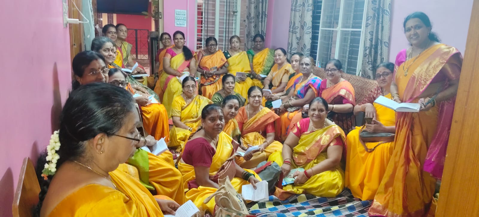 Blessing with akshate during a parayana at a devotee's home