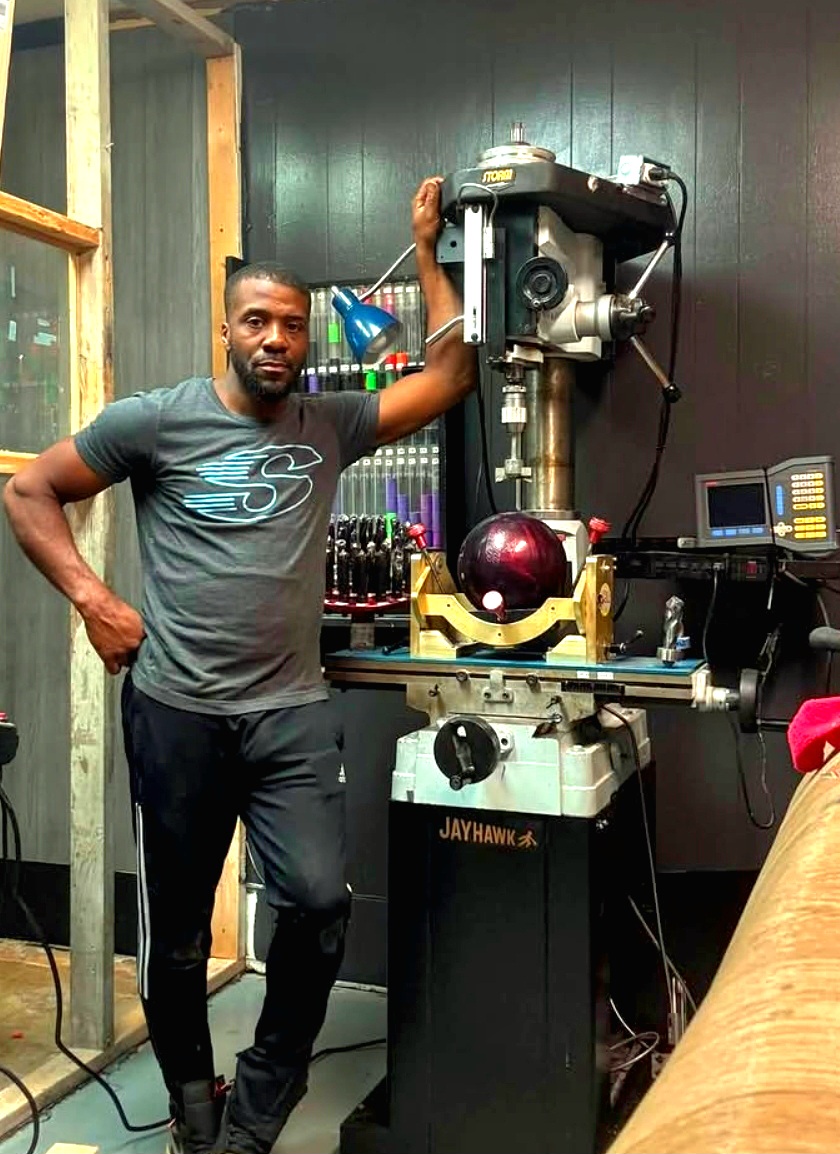 Mason at the drill press wearing a Storm shirt