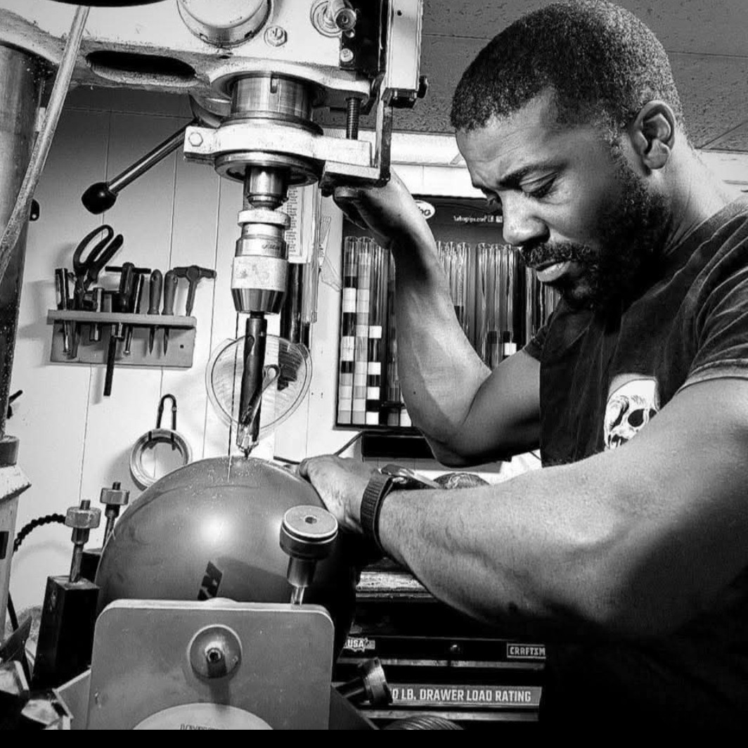 Close-up of a ball being drilled on the drill press