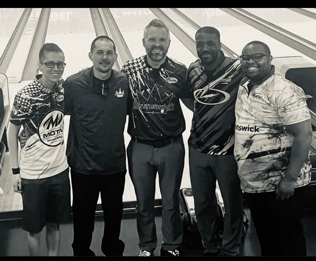 Team of five bowlers in tournament jerseys